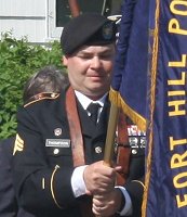 Rob Thompson in the 2016 Memorial Day parade holding the Post 376 colors.