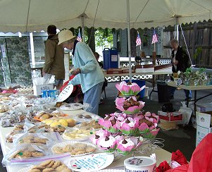 Barb Bogie readies the baked goods at the 4th Great Garage Sale.